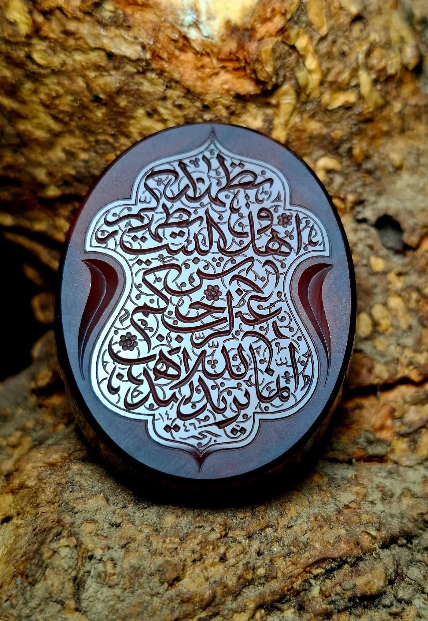 Stone Engraving by Mohsen Karimi. Reddish stone with Victorian style writing in Arabic sols